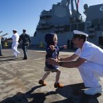 Amelia Carpenter, 3, runs to her father, Chief Travis Carpenter, during the USS Sampson (DDG 102) arrival at Naval Station Everett on Sept. 26, 2016, in Everett. The Arleigh-Burke Class destroyer is the second of four new destroyers to be based in Everett. (Andy Bronson / The Herald)