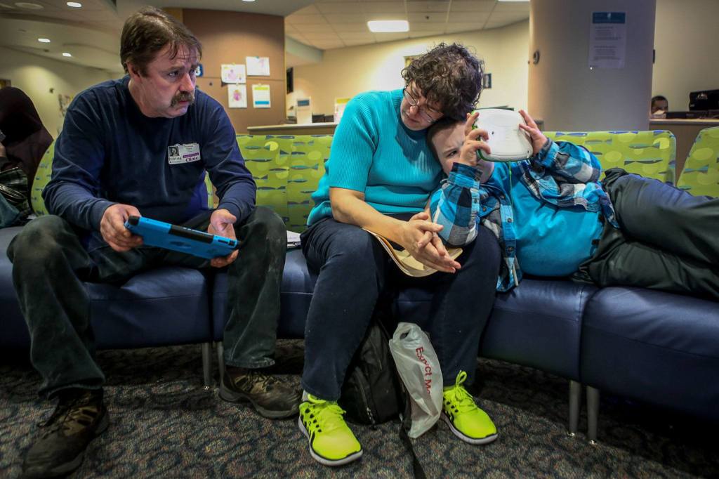 Sam, Cheryl and Jessie Pyles await a surgical consult at Children&rsquo;s Hospital in Seattle. Due to Jessie&rsquo;s various medical conditions resulting in many doctors visits, he is medicated and can have unpredictable behaviors. (Kevin Clark / The Herald)