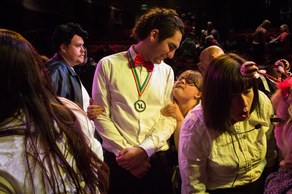 Young Life Leader Josh Tremain smiles at Faith Fitch, who performed during the Snohomish County Capernaum&rsquo;s Got Talent Variety Show hosted by Young Life on December 5, 2015. The evening showcased the talents of young people living with disabilities as they performed onstage in the Public Utility District building.
