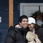 Ray and Sandy Flores hug on their front porch after accepting the keys, earlier that morning, to their new home from Habitat for Humanity of Snohomish County on Saturday, Dec. 17, 2016 in Everett. The Flores and their three young kids became the new owners of Phoenix II, a house in North Everett, which they contributed over 500 hours of sweat equity in its construction. (Andy Bronson / The Herald)