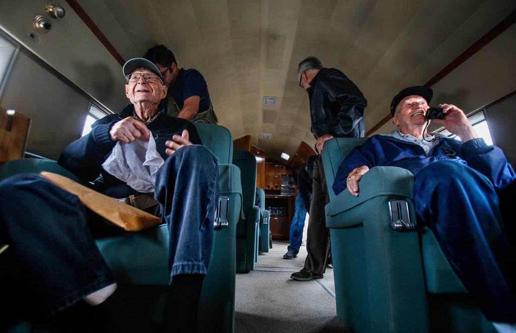 During a pre-flight talk to the passengers, foundation president John Sessions warned that although no injuries have occured on previous flights, one possilble side effect can be facial strain, caused by excessive smiling. Preparing for take off, only moments after boarding, it appears that WWII pilots Elden Larson and Art Unruh, both 93, are already showing symptoms. (Dan Bates / The Herald)