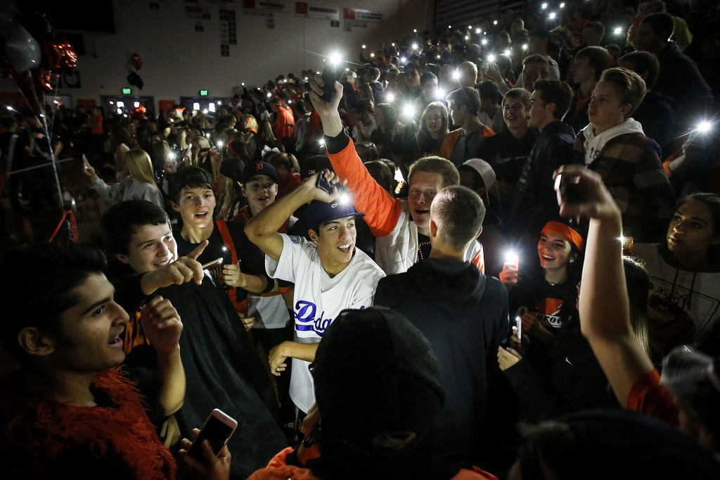 Monroe High School seniors, including Brian Pino (center in white), dance during a kickoff assembly Friday morning at the school to promote homecoming events scheduled for the upcoming week. To avoid the popularity contest that typically occurs to pick a homecoming king and queen, Monroe High School decided to change the traditional format by nominating 40 students total from all fall sports and clubs. (Ian Terry / The Herald)