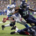 Seahawks strong safety Kam Chancellor (31) knocks the ball loose from Lions wide receiver Calvin Johnson (81) in the closing seconds of a game Oct. 5, 2015, in Seattle. The fumble went out of bounds in the end zone and was ruled a touchback. The Seahawks beat the Lions 13-10. (AP Photo/Elaine Thompson)