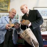 Mike Papadimitriou, owner of People&rsquo;s Shoe Repair, talks with Michael Held about repairing heels on a pair of saddle shoes. (Andy Bronson / The Herald)
