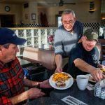 Running the restaurant entirely by himself Tuesday, Joe Weller serves a Speedway Special to Tom Cook (left) and an omelet to Lou Pirone, plus another special and omelet to two more friends, Ben Rico and Tom Lamb, sitting across the table. The men, friends from Lynnwood, are longtime regulars at Weller&rsquo;s. (Dan Bates / The Herald)