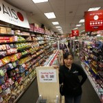 Asami Moretro stands in an aisle at Daiso, a Japanese dollar store that she manages located inside the Alderwood mall in Lynnwood. (Ian Terry / The Herald)