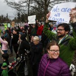 Marty Ross (right) and Leah Ross (center right), of Lake Forest Park, stand at the corner of 100th Avenue West and Edmonds Way during a gathering in Edmonds on Sunday, Jan. 29. The protest aimed to raise awareness and voice opposition to President Trump&rsquo;s executive order banning immigrants from seven Muslim-majority countries from entering the U.S. The executive order, signed on Friday, triggered massive protests at airports across the country as details came out about refugees and other visitors being detained despite having all documents necessary for entry into the U.S. (Ian Terry / The Herald)