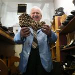 Mike Papadimitriou, owner of People&rsquo;s Shoe Repair, holds up a leopard print high heel shoe left behind by a customer. Papadimitriou has been the sole proprietor since 1968. (Andy Bronson / The Herald)