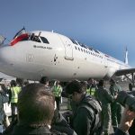 The pilot of Iran Air&rsquo;s new Airbus plane waves with an Iranian flag after landing at Mehrabad airport, in Tehran, Iran, on Thursday, Jan. 12. The first of 100 Airbus planes that Iran is expected to receive after its historic nuclear deal with world powers ended some sanctions landed on Thursday in the capital, Tehran. (AP Photo/Vahid Salemi)