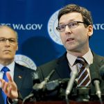 Washington Attorney General Bob Ferguson (right) talks to reporters with Gov. Jay Inslee on Monday in Seattle. Ferguson announced that the state is suing President Donald Trump over an executive order that suspended immigration from seven countries with majority-Muslim populations. (AP Photo/Ted S. Warren)