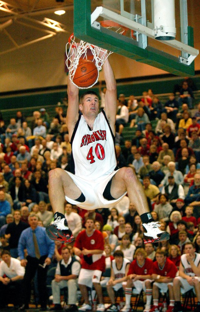 Jon Brockman slams the ball through during a playoff game against Mariner High. Year unknown. (Dan Bates / Herald file)