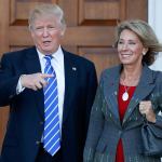 In this Nov. 19, 2016 photo, President-elect Donald Trump and Betsy DeVos pose for photographs at Trump National Golf Club Bedminster clubhouse in Bedminster, New Jersey. (AP Photo/Carolyn Kaster, File)