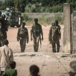 Local children look toward Senegal soldiers at the Gambia border with Senegal at the town of Karang, Senegal, on Friday, Jan. 20. Gambia&rsquo;s defeated President Yahya Jammeh must cede power by noon Friday or he will be dislodged by a regional force that has already moved into the country, West African officials said. (AP Photo/Sylvain Cherkaoui)
