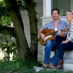 Mark Mulligan / The Herald File Josh and Genevieve Clauson relax in front of their home.