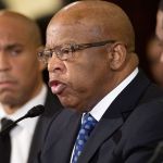 Rep. John Lewis, D-Ga. (center) flanked by Sen. Cory Booker, D-N.J., (left) and Congressional Black Caucus Chair Rep. Cedric Richmond, of La., testifies on Capitol Hill in Washington, D.C., on Wednesday. (Cliff Owen / Associated Press)
