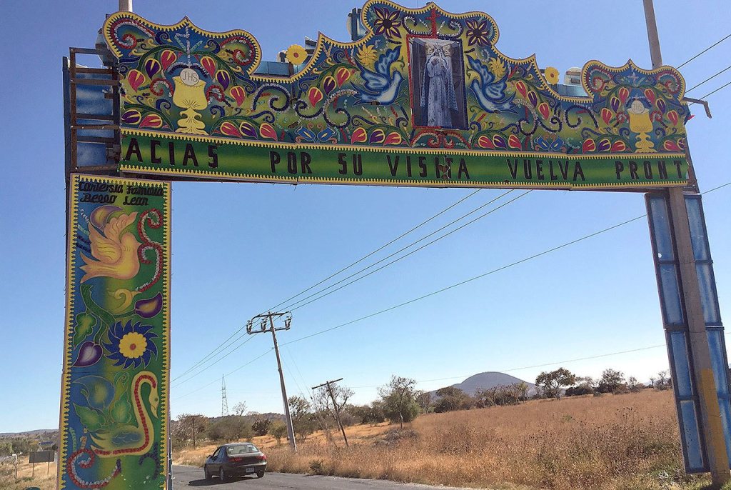 An arch welcomes visitors to Molcaxac, Puebla, Mexico. Folks here say so many working-age residents have migrated to the U.S., the town is mostly populated by the elderly and the very young. (AP Photo/Peter Orsi)