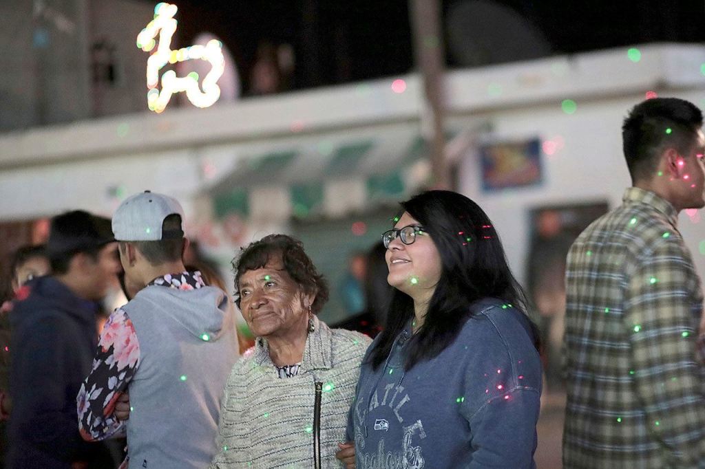 Tamara Alcala Dominguez and her grandmother, Petra Bello Suarez, attend a holiday party in their home town of Molcaxac, Puebla, Mexico, during Alcala&rsquo;s first return home since she left Mexico for the U.S. as a toddler. (AP Photo/Pablo Spencer)