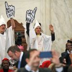 Demonstrators are seen on Capitol Hill in Washington on Tuesday, Jan. 10, during the Senate Judiciary Committee&rsquo;s confirmation hearing for Attorney General-designate, Sen. Jeff Sessions, R-Ala. (AP Photo/Andrew Harnik)