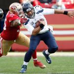 Seahawks quarterback Russell Wilson (3) scrambles away from 49ers linebacker Ahmad Brooks during the first half of a game this past Sunday in Santa Clara, Calif. (AP Photo/Tony Avelar)