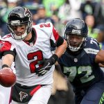Falcons quarterback Matt Ryan looks to hand off the ball with Seahawks defensive lineman Michael Bennett closing during a game Oct. 15 at CenturyLink Field in Seattle. (Kevin Clark / The Herald)