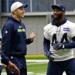 Seahawks fullback Marcel Reece (right) talks with offensive coordinator Darrell Bevell (left) after practice Tuesday in Renton. The Seahawks face the Falcons in an NFC playoff game Saturday in Atlanta. (AP Photo/Ted S. Warren)