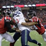 Falcons punter Matt Bosher (5) and cornerback C.J. Goodwin (29) tackle the Seahawks&rsquo; Devin Hester (17) during a punt return in the first half of a playoff game Saturday in Atlanta. (AP Photo/David Goldman)
