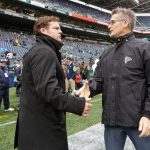Seahawks general manager John Schneider (left) shakes hands with Falcons general manager Thomas Dimitroff (right) before a game Oct. 16, 2016, in Seattle. (AP Photo/Elaine Thompson)
