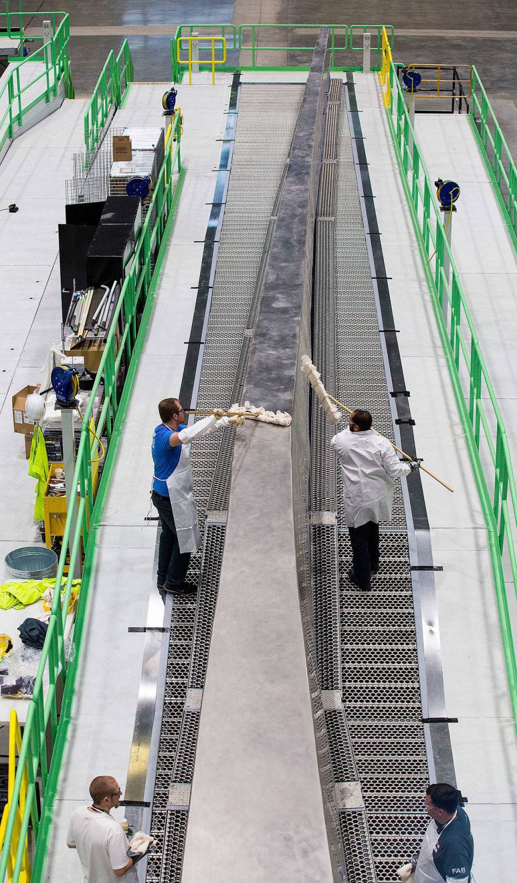 At Boeing&rsquo;s Composite Wing Center, workers wipe down a wing spar tool as the company moves closer to production of the 777X. (Andy Bronson / The Herald)