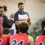 Snohomish assistant basketball coach and former NBA and University of Washington player Jon Brockman applauds his team prior to a game at Edmonds-Woodway High School on Friday. (Daniella Beccaria / The Herald)
