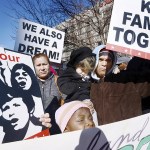 Isaias Juarez with daughter&rsquo;s Anarhu join a gather in in downtown Durham, North Carolina, on Friday, Jan. 27, to show their support for refugees and immigrants and stand against President Donald Trump&rsquo;s plan to ban refugees of Muslim countries. (Bernard Thomas/The Herald-Sun via AP)