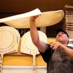 Joaquin Cruz tosses dough to make a pizza pie Friday afternoon at Brooklyn Bros. Pizzeria at the downtown Everett shop. The business plans to open new sites in Mill Creek and Camono Island. (Kevin Clark / The Herald)