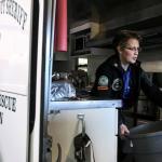 Debra Draper clears the aisle during her weekly maintenance on SSAR 70, the food truck. Draper joined Snohomish County Volunteer & Resuce during the Oso mudslide response and operates the food truck. (Kevin Clark / The Herald)