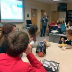 Evergreen Middle School students eat lunch as they learn about STEM-related careers from Snohomish County Principal Planner Randy Middaugh during a Lunch and Learn session. (Contributed photo)