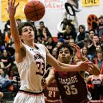 Monroe&rsquo;s Colby Kyle reaches out for a loose ball with Cascade&rsquo;s Dauntay Woods trailing Thursday night in Monroe on January 12, 2017. The Bearcats won 57-43. (Kevin Clark / The Herald)