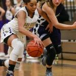 Lake Stevens&rsquo; Raigan Reed (left) and Kamiak&rsquo;s Alex Gallaher vie for control of a loose ball Wednesday night in Lake Stevens. The Vikings won 65-61. (Kevin Clark / The Herald)