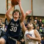 Glacier Peak&rsquo;s Bobby Martin attempts a shot with Kamiak&rsquo;s Swell Ewing defending Friday night at Kamiak High School in Mukilteo. The Grizzles won 63-50. (Kevin Clark / The Herald)