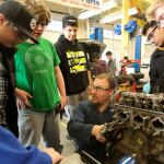 Bryan Robbins (center) explains a component of an engine Thursday afternoon at Meadowdale High School in Lynnwood. (Kevin Clark / The Herald)