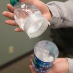 A Dasani water bottle with a hidden compartment in the middle behind the logo is held by a parent during a search for hidden drugs in a model bedroom at Weston High on Thursday, Jan. 19, in Arlington. The &ldquo;Not in My House!&rdquo; event was put on by the Arlington Drug Awareness Coalition. (Andy Bronson / The Herald)