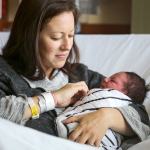 Maxwell Daniel Hansen, held by his mother, Heather Hansen, was the first baby born in the new year at Providence Women&rsquo;s and Children Center in Everett. (Kevin Clark / The Herald)