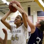 Lake Stevens&rsquo; Kylee Griffen attempts a shot with Kamiak&rsquo;s Alex Gallaher (right) defending Wednesday night in Lake Stevens. The Vikings won 65-61. (Kevin Clark / The Herald)