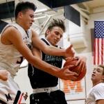 Monroe&rsquo;s Spencer Davidson (left) and Jackson&rsquo;s Ian Willgress battle for control of a rebound during a game Friday night at Monroe High School. Monroe won 70-58. (Kevin Clark / The Herald)