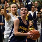 Mariner&rsquo;s Seijin Dupuy drives the baseline with Kamiak&rsquo;s Olivia Albright trailing during the Knights&rsquo; 43-34 Unified basketball victory over Mariner in Mukilteo on Thursday. It was the first-ever Unified game between the two schools in the Mukilteo School District. (Kevin Clark / The Herald)