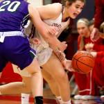 Stanwood&rsquo;s Madison Chisman (right) is fouled in the open court by Edmonds-Woodway&rsquo;s Adrienne Poling during a game Wednesday night in Stanwood. The Spartans won 67-36. (Kevin Clark / The Herald)