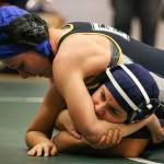 Everett&rsquo;s Sierra Chapman (top) wrestles Arlington&rsquo;s Itzel Ceja during a match Thursday night at Everett High School. (Kevin Clark / The Herald)