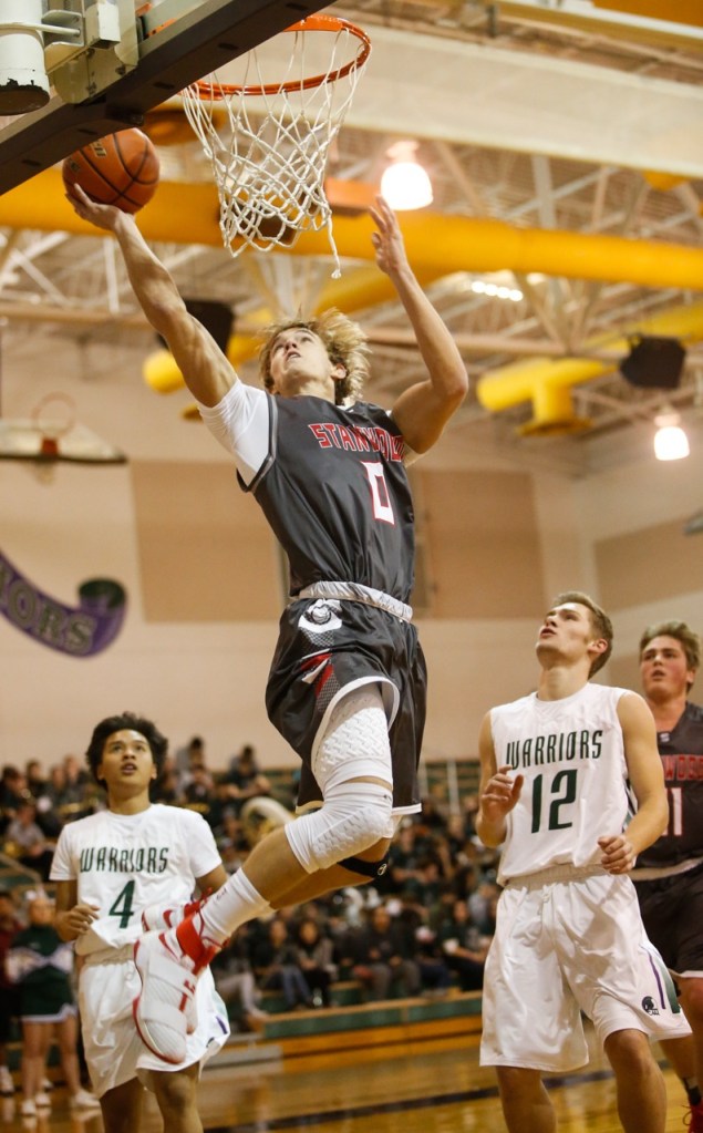 Stanwood&rsquo;s AJ Martinka (0) scores against Edmonds-Woodway during a game Tuesday at Edmonds-Woodway High School in Edmonds. Stanwood won 85-66. (Daniella Beccaria / The Herald)