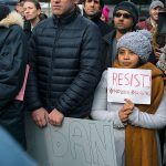 Protesters assemble at John F. Kennedy International Airport in New York on Saturday, Jan. 28, after two Iraqi refugees were detained while trying to enter the country. (AP Photo/Craig Ruttle)
