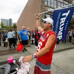 Clay Owen, of Birch Bay, walks down Hewitt Avenue with his flag before a rally for Republican presidential nominee Donald Trump on Aug. 30, 2016. (Ian Terry / Herald file)