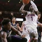 Arizona guard Rawle Alkins (1) draws the foul on Washington forward Noah Dickerson (15) during the second half Sunday, Jan. 29, in Tucson, Ariz. (AP Photo/Rick Scuteri)