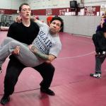 Cascade&rsquo;s Adam Holston carries his coach, Brooklyn Obregon, in strength drills during practice at Cascade High on Jan. 18. After the death of his father, Jery, in June of 2016, Holston moved in with Obregon and his wife, Cindy. (Kevin Clark / The Herald)