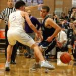 Glacier Peak&rsquo;s Austin Petz attempts to shake the defense of Kamiak&rsquo;s Christian Clausen during a game Friday night at Kamiak High School in Mukilteo. The Grizzles won 63-50. (Kevin Clark / The Herald)